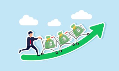Bir işadamı, yükselen yeşil bir tabloda para çantalarıyla dolu bir sıra alışveriş arabası itiyor, iş varlıklarının ve gelirlerinin artışının bir göstergesi olarak.
