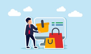 Elinde alışveriş arabası olan bir işadamı, bir monitör ve alışveriş çantasının yanında duruyor.