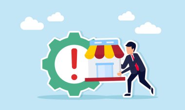 İş adamı, pazar yeri yönetimi ve sistemleriyle ilgili bakım ve iyileştirme işaretleri içeren bir dişlinin yanında bir mağaza tutuyor.