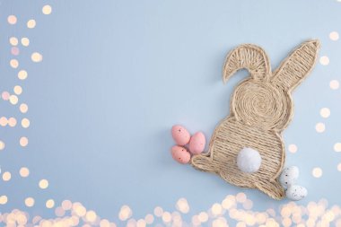 Handmade easter bunny made of strings with eggs and lights, top view