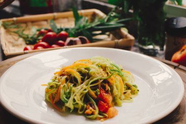Vegan pasta, a sliced vegetable salad, close up