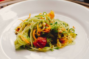 Vegan pasta, a sliced vegetable salad, close up