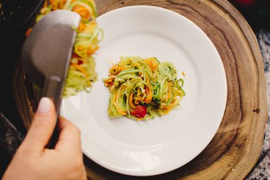Vegan pasta, a sliced vegetable salad, top view