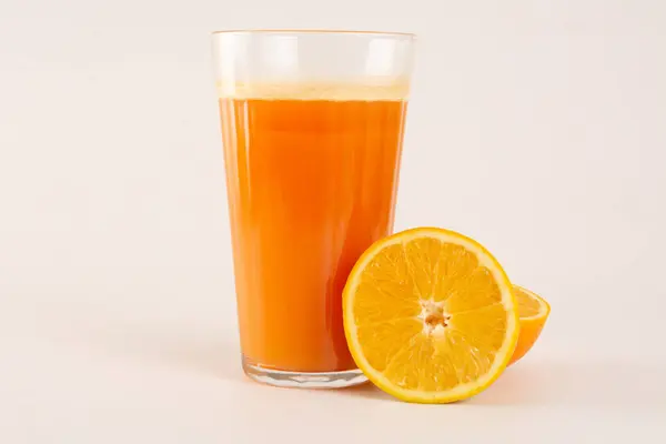Fresh Organic Orange Juice with sliced orange fruit in a glass cup in white background in front view