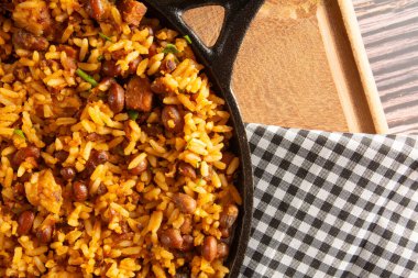 Baiao de Dois traditional Brazilian food with rice, beans, sausage and rennet cheese close up clipart