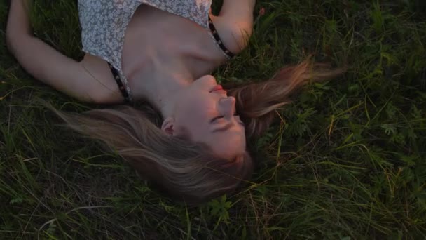 Young Beautiful Girl Lies Field Grass Backdrop Summer Sunset Slow — Stock Video