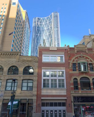 Calgary, Alberta/ Canada - December 11 2022: Front and perspective view of buildings and facades on Steven Avenue in downtown Calgary, Alberta clipart