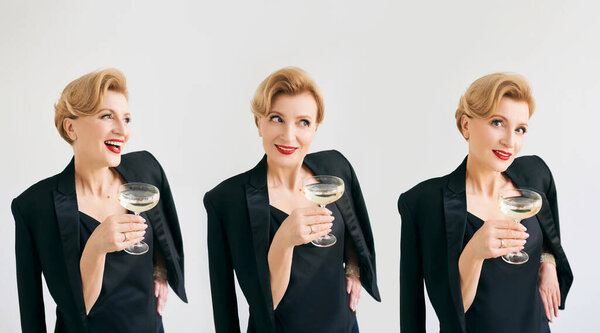 three mature stylish elegant women twins in tuxedo with glass of sparkling wine. Party, celebration, anti age concept 