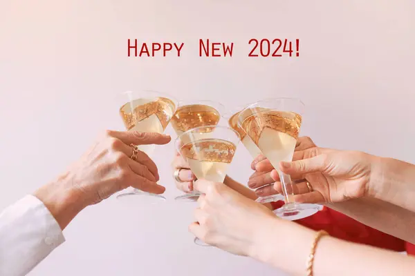 new year celebrating hands with glasses of white sparkling wine. Christmas, family, friends, celebrating, new year concept