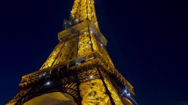 パリの街の夕暮れに輝くエッフェル塔の近く 夜のイルミネーションでエッフェル塔を見る エッフェル塔はパリで最も訪問されたモニュメントです パリの夢 — ストック動画