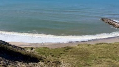Bovbjerg deniz feneri ve Kuzey Denizi 'nden uçurumlar, Ferring, Lemvig, Jutland, Danimarka. Danimarka 'nın kayalıkları ve plajları. Kuzey Denizi kıyısındaki uçurum Bovbjerg Fyr deniz feneri ve okyanus, tatil