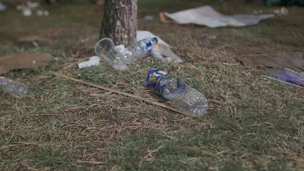 Bottle and plastic waste is scattered around