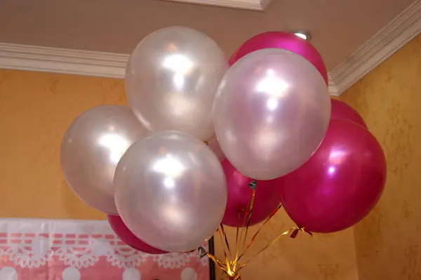 some pink and white balloons