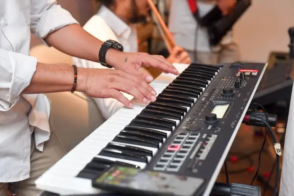close up of pianist\'s hands and keyboard