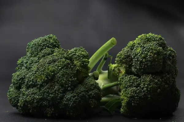 stock image Fresh green broccoli on black background