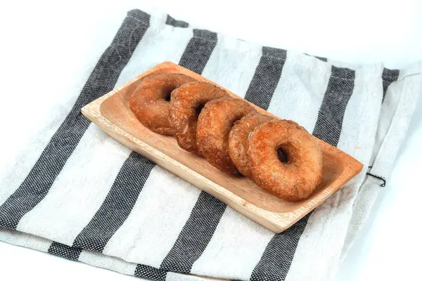 stock image Kue Cincin often called Donut Cake, or Ali Agrem is a cake that is served as a daily snack. It is made from brown sugar mixed with rice flour, on wooden plate