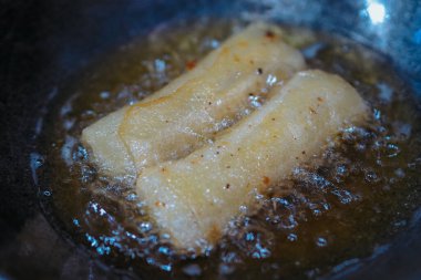 The rissoles are being fried in a frying pan, the croquettes are being fried, good for recipes or commercial clipart