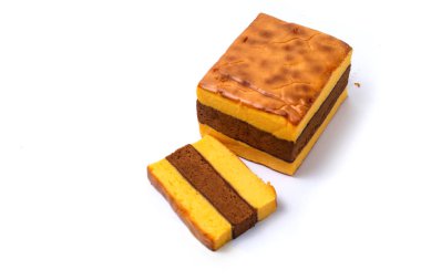 Lapis Surabaya or Surabaya layer cake, is an Indonesian three layer rich sponge cake and strawberry jam in between, isolated on white background