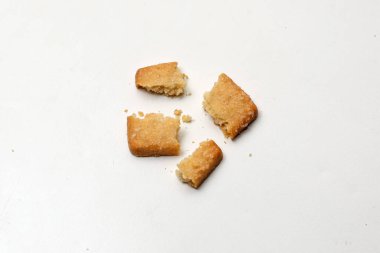 Beyaz arka planda kırık Danimarka kurabiyeleri, dörde bölünmüş