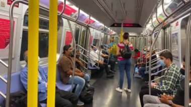 This video shows views of people wearing a face mask during the Coronavirus era on a subway train while heading from Brooklyn to downtown Manhattan.