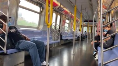 This video shows views of people wearing a face mask during the Coronavirus era on a subway train while heading from Brooklyn to downtown Manhattan.