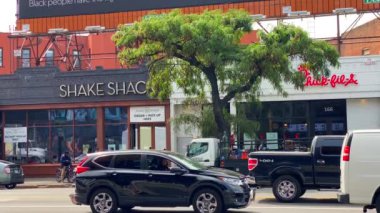 This video shows views of businesses and a billboard sign near Barclays Center in downtown Brooklyn.  Barclays Center is a multi-purpose indoor arena in the New York City borough of Brooklyn and is home to the NBAs Brooklyn Nets. 