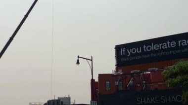 This video shows views of businesses and a billboard sign near Barclays Center in downtown Brooklyn.  Barclays Center is a multi-purpose indoor arena in the New York City borough of Brooklyn and is home to the NBAs Brooklyn Nets. 