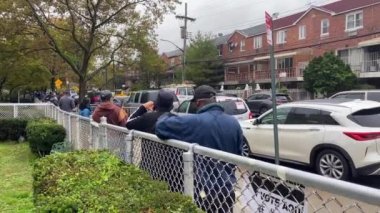 This video shows a line of African American people coming out early to vote for a new president in the critical 2020 presidential election during a Covid-19 pandemic.  