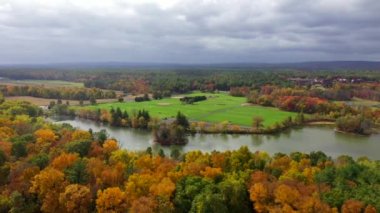 This video shows gorgeous aerial views of colorful trees during the fall season.
