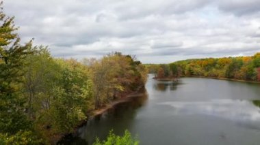 This video shows gorgeous aerial views of colorful trees during the fall season.
