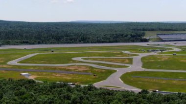 This video shows views of go-kart racing at the Pocono Raceway. 