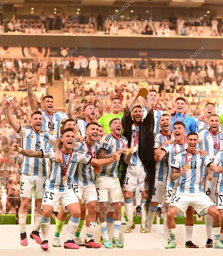 Luseyl, QATAR - DEC 18 2022: Lionel Messi and team friends celebrating with the championship cup at the World Cup match between Argentina and France at the Luseyl Stadium on December 18, 2022