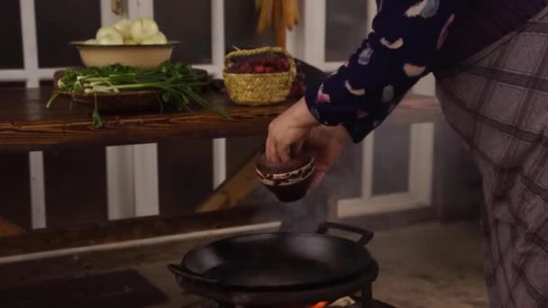 Pouring Salt Large Water Filled Pan Burning Wood Fire — Vídeo de stock