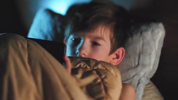 Ett Barn Sängen Filt Med Telefon Händerna Liten Pojke Tittar — Stockvideo