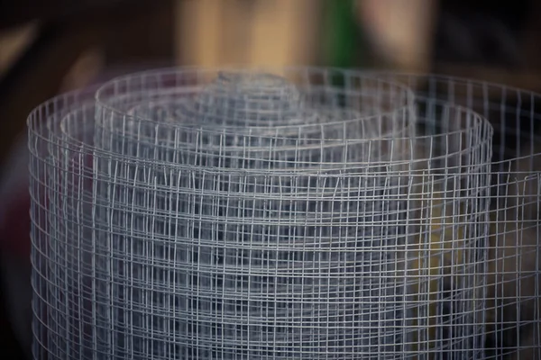 Metal mesh close-up, metal background slightly blurred. Metal grid for welding. Metal construction for ventilation