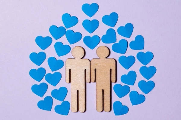 stock image Male love LGBT. Same-sex family icons. gay couple of two homosexual men. The male couple is holding hands. Wooden people with paper blue hearts