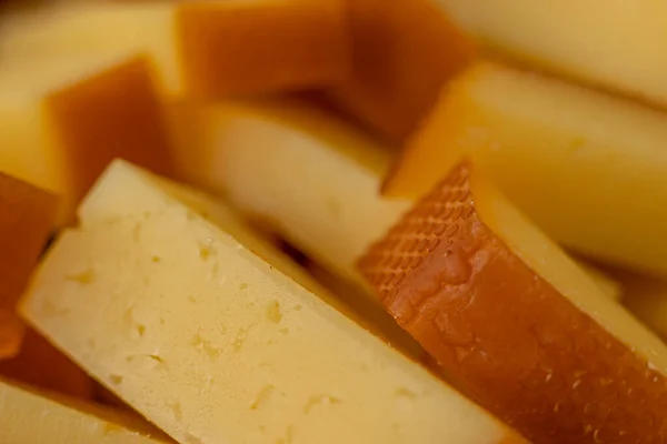 stock image Cheese snacks in one container. Sliced cheese in different shapes. Cheese board for the celebration