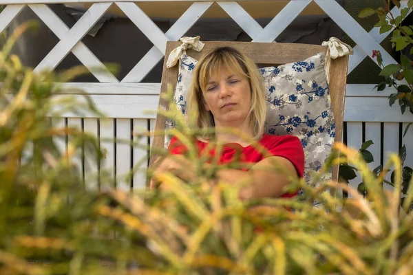 stock image A tired woman fell asleep outside on a chair after hard work. Women's fatigue. Vegetative dystonia female fatigue