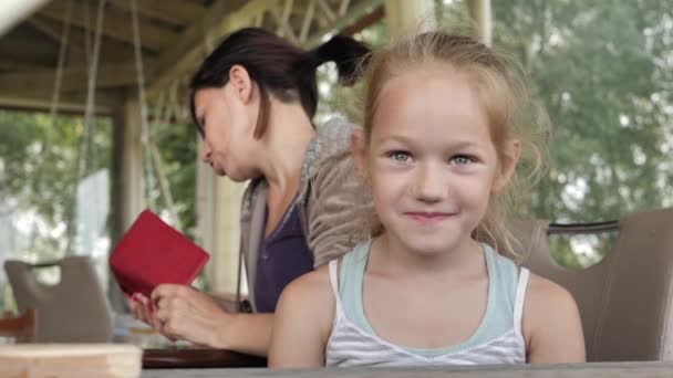 Ένα Κοριτσάκι Όμορφα Μάτια Παιδί Κάθεται Στο Τραπέζι Μητέρα Του — Αρχείο Βίντεο