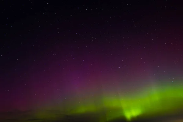 Stock image Latvian Night Sky Green Aurora in autumn. Tranquil scene of nighttime aurora, illuminated green landscape, starry celestial beauty. Tranquil Night Sky, Green Aurora Illuminating Celestial Landscape