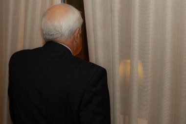 İçerideki Kamerada Gülümseyen Mutlu İş Adamı. Resmi olarak gülümseyen yaşlı işadamı perde arkasında giyinir..