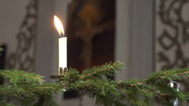 Kilisedeki Noel ağacında mum yakmak.