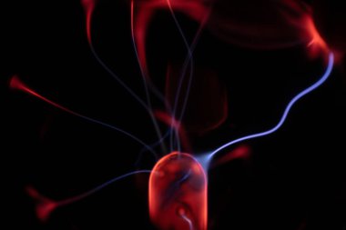 Kırmızı ve mavi enerji yayı ile parlayan bir plazma topu koyu bir arkaplana yayılarak canlı ve heyecan verici bir görsel efekt yaratır.