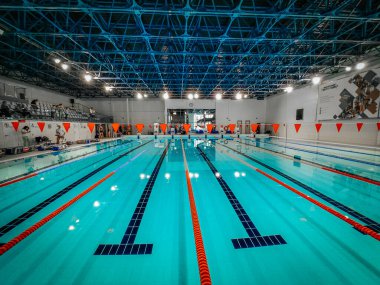 Indoor swimming pool with multiple lanes, bright lighting, and a clean design. Ideal for training, competitions, and recreational swimming in a professional sports facility