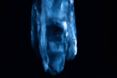 Bozulmuş, yarı saydam sıvı bir şekil, hareketin ortasında asılı, mavi ve altın ışıkla aydınlatılmış, koyu bir arkaplanda çizgiler çiziyor. Kopyalama alanı içerir.