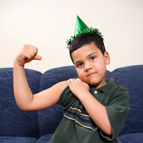 Boy Party Hat Flexing Arm Muscle — Stock Photo, Image