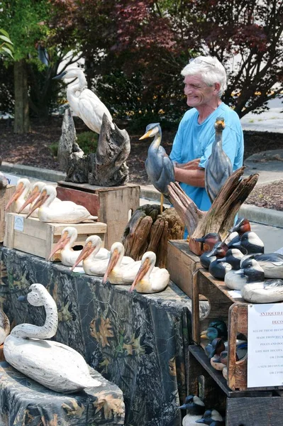 stock image man sell decoys birds