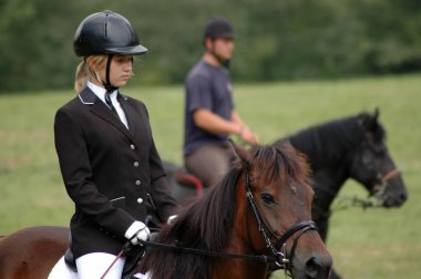 blonde girl riding a horse