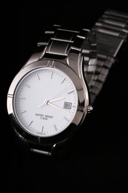 silver watch on dark background