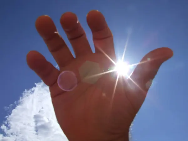 Man's Hand Sun And Blue Sky